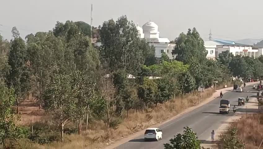 Road and buildings in owner-supplied sugar factory land footage